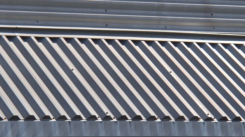 A standing seam metal roof panel run, showing the raised vertical seams that join each panel